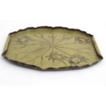 A Japanese signed brass embossed leaf form having four crafts embossed decoration.