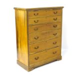 A mid 20thC mahogany chest of drawers comprising six long graduated drawers with checkered inlay