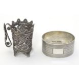 A silver napkin ring of ovoid form with banded engine turned decoration Birmingham 1958 maker