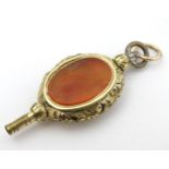 Victorian pocket watch key : a pendant gilt metal intaglio carnelian pocket watch key with image of