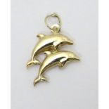 A gilt metal pendant / charm formed as a pair of dolphins 3/4" long CONDITION: