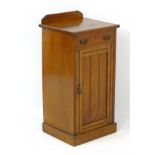 A late 19thC / early 20thC mahogany cabinet with canted upstand above single short drawer and