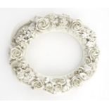 An early Belleek style porcelain oval frame with encrusted flowers. Unmarked. Approx.
