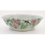 An oriental quatrefoil/lozenge shaped dish with hand painted decoration to include Chinese