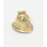 A novelty 9ct gold charm / pendant formed as a policeman's helmet.