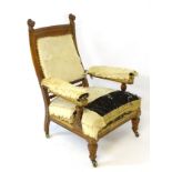 A late 19thC yew open armchair with carved lion’s head terminals, a gadrooned top rail,
