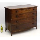 A mid 19thC mahogany chest of drawers comprising four oak lined graduated drawers,