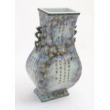 A Chinese fanghu vase with a mottled blue and grey ground and Chinese character decoration,