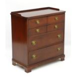 A mid 20thC mahogany chest of drawers comprising four long drawers with Georgian style handles and