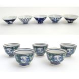 Five oriental rice bowls with blue and white pattern decoration,