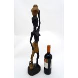 Ethnographic Native Tribal : a carved wooden figure of a water carrier ,