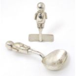 A silver plate Christening set comprising spoon and pusher with handles formed as stylised Kewpie