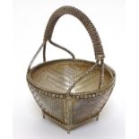 A small white metal basket with basket weave and gilt decoration. Possibly Indian. Approx 3" high.