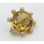 A late 19thC / early 20thC gilt metal brooch set with facet cut citrine bordered by 8 pearls.