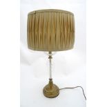 A lacquer brushed bronze effect and glass table lamp with pleated silk shade glass and brass lamp