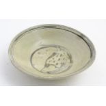 A Chinese Ming Dynasty celadon glazed bowl with hand painted fish decoration to the centre and