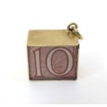 A Vintage 9ct gold pendant charm containing a 10 shilling note and marked ' In an Emergency Break