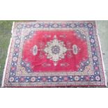 Rug carpet: A large handmade carpet with a red centre ground having yellow, green, sage green,