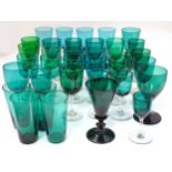 A quantity of green wine glasses and tumblers of various ages.