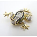 A late 20thC 14ct gold brooch formed as a frog set with a profusion of diamonds,