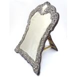 A silver framed easel back mirror,