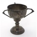 A small silver trophy cup with three handles. Hallmarked Sheffield 1920.
