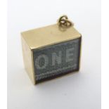 A Vintage 9ct gold pendant charm containing a £1 note and marked ' In an Emergency Break Glass ' 1