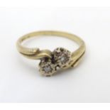 An early 20thC vintage 9ct gold ring set with two illusion set diamonds totalling approx 0.5ct.