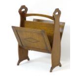 Arts & Crafts: An oak magazine rack with diamond decoration to opening sides,