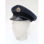 Militaria: A mid 20thC Royal Air Force ensign peaked cap with applied RAF badge,