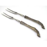 A pair of Late 19thC / early 20thC two tine forks having handles formed as animal legs with cloven