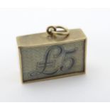 A Vintage 9ct gold pendant charm containing an old £5 note and marked ' In an Emergency Break Glass