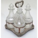 A 4- bottle Sheffield plate stand with 4 cut glass small decanters.