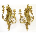 A pair of late 19thC gilt wood and gesso 2-branch wall sconces in the form of scrolling acanthus.