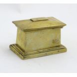 A cast brass 19thC miniature sarcophagus, the top removing to reveal space within.