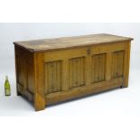 A 17thC oak Coffer of large proportions with a linen fold panelled front,