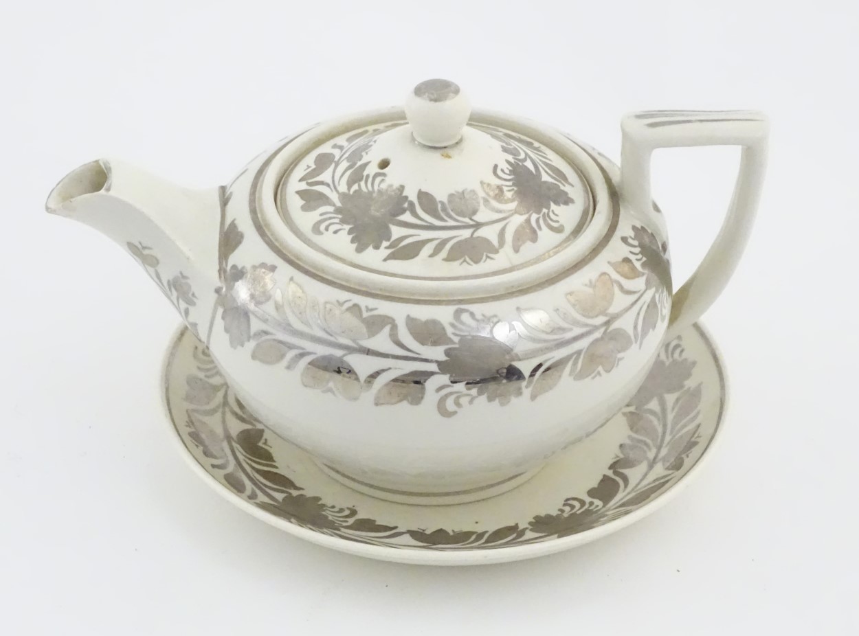 A white Wedgewood teapot and saucer with banded silver lustre decoration. Teapot approx.