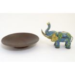 A hammered copper dish together with a cloisonne and gilt decorated elephant.