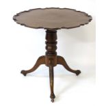 A Georgian and later mahogany tripod occasional table with a pie crust / dished top above a heavy
