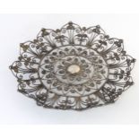 A white metal four footed dish with openwork decoration 7 1/4" diameter CONDITION: