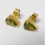 A pair of gilt metal stud earrings set with peridot green stones CONDITION: Please