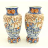 Two Imari vases depicting a garden landscape. Approx. 12" high.