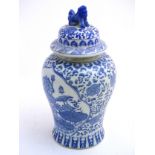 A large blue and white ginger jar decorated with stylised flowers and banded Greek key,