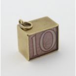A Vintage 9ct gold pendant charm containing a 10 shilling note and marked ' In an Emergency Break