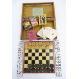 An Edwardian games box with instructions for playing the game Quartette to the inside lid,