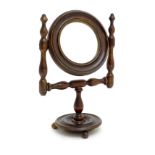 A small proportion c.1900 pedestal mirror on circular stand.