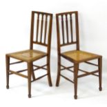 A pair of early 20thC mahogany chairs with caned seats,