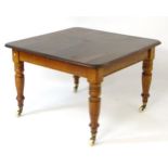 A Victorian mahogany dining table with moulded square top,