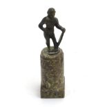 A desk ornament depicting a patinated cast brass image of native upon a turned and decorated marble