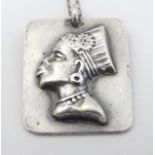 A silver pendant with image of South African female head.